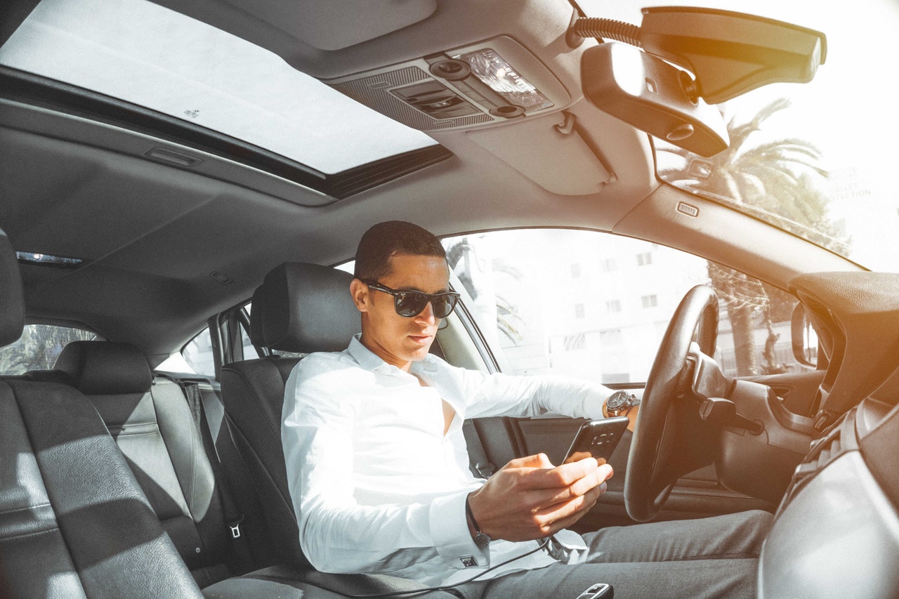 man using cell phone while driving