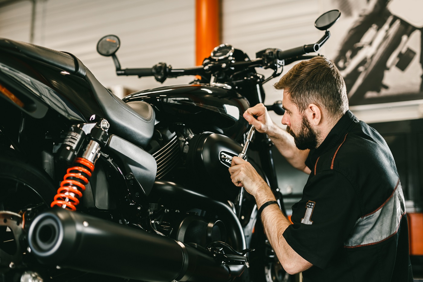 Professional mechanic working screwdriver and motorcycle repairs